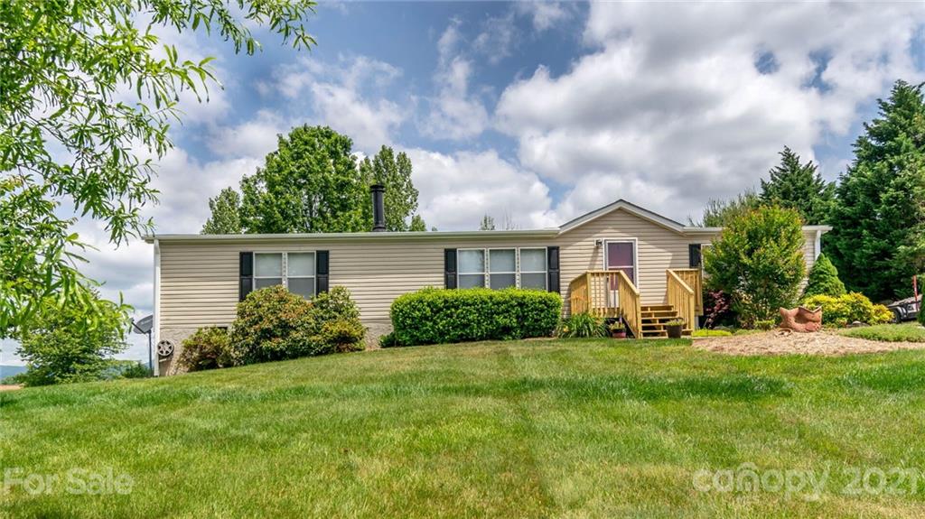 449 Divide Loop Flat Rock, NC 28731 - Photo 30 of 36 a front view of a house with a yard and garage