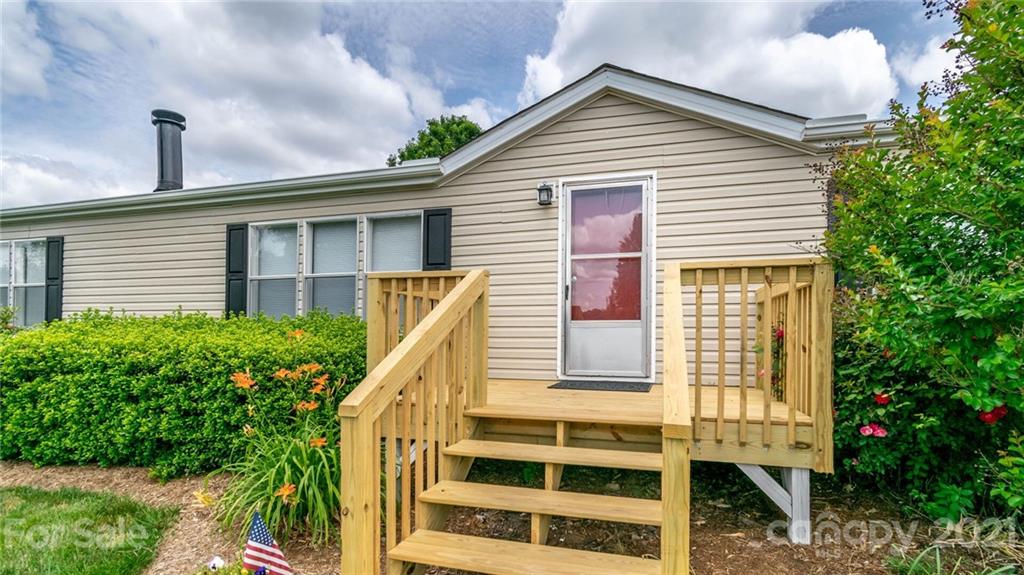 449 Divide Loop Flat Rock, NC 28731 - Photo 4 of 36 a view of a house with a yard and potted plants