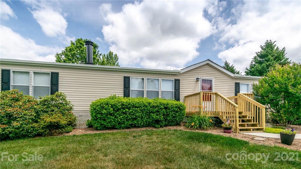 449 Divide Loop Flat Rock, NC 28731 - Photo 32 of 36 a view of a house with a yard and potted plants