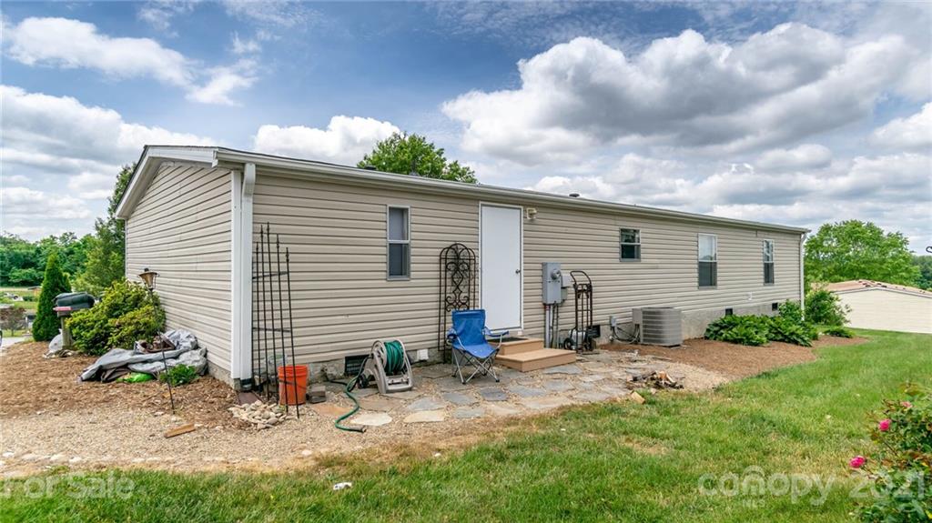 449 Divide Loop Flat Rock, NC 28731 - Photo 35 of 36 a backyard of a house with table and chairs