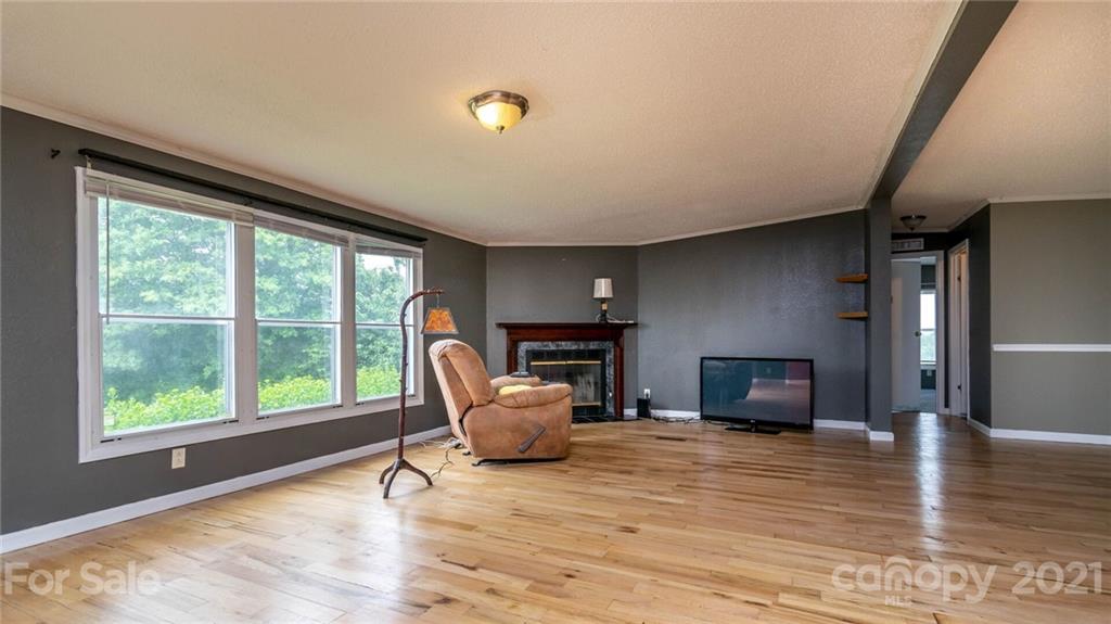 449 Divide Loop Flat Rock, NC 28731 - Photo 6 of 36 a living room with furniture and a flat screen tv