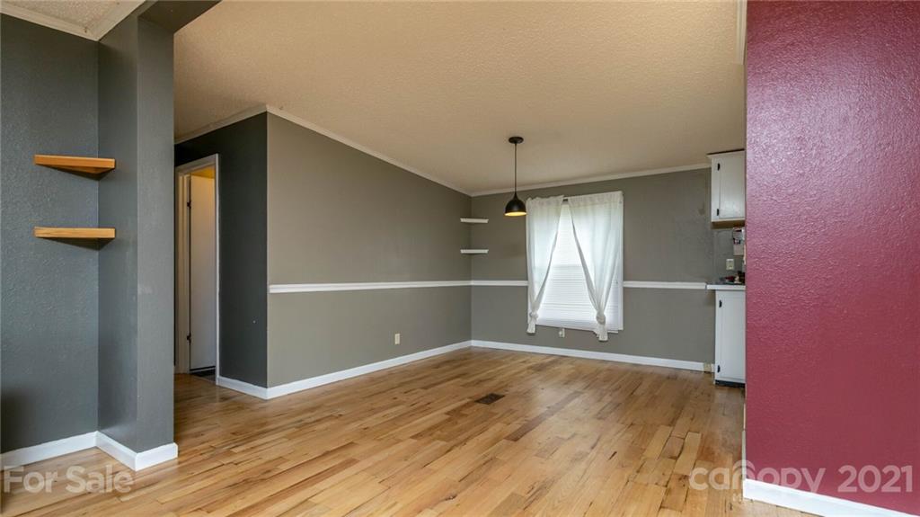 449 Divide Loop Flat Rock, NC 28731 - Photo 9 of 36 an empty room with wooden floor and windows