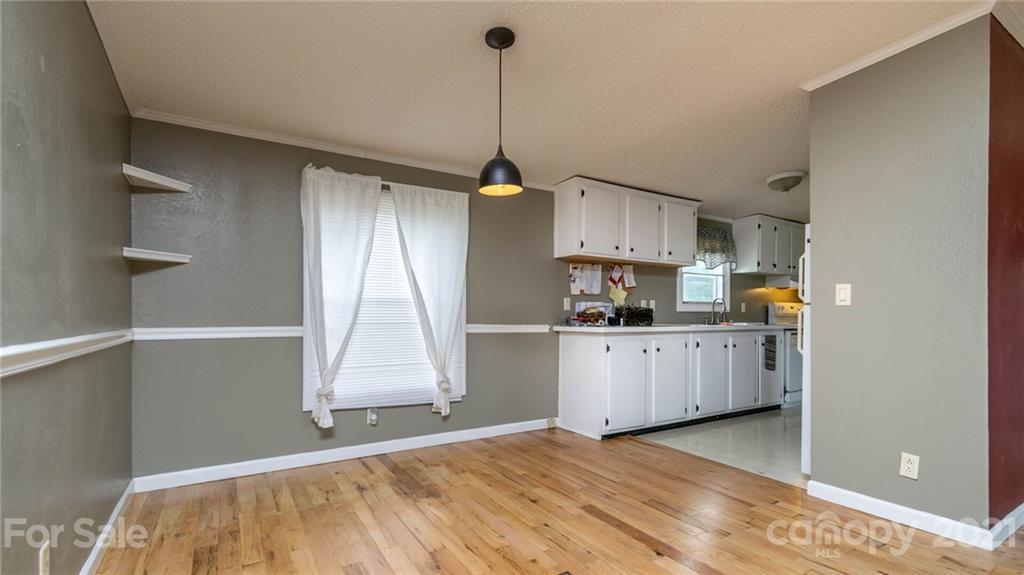 449 Divide Loop Flat Rock, NC 28731 - Photo 10 of 36 a kitchen that has a lot of cabinets in it and wooden floor