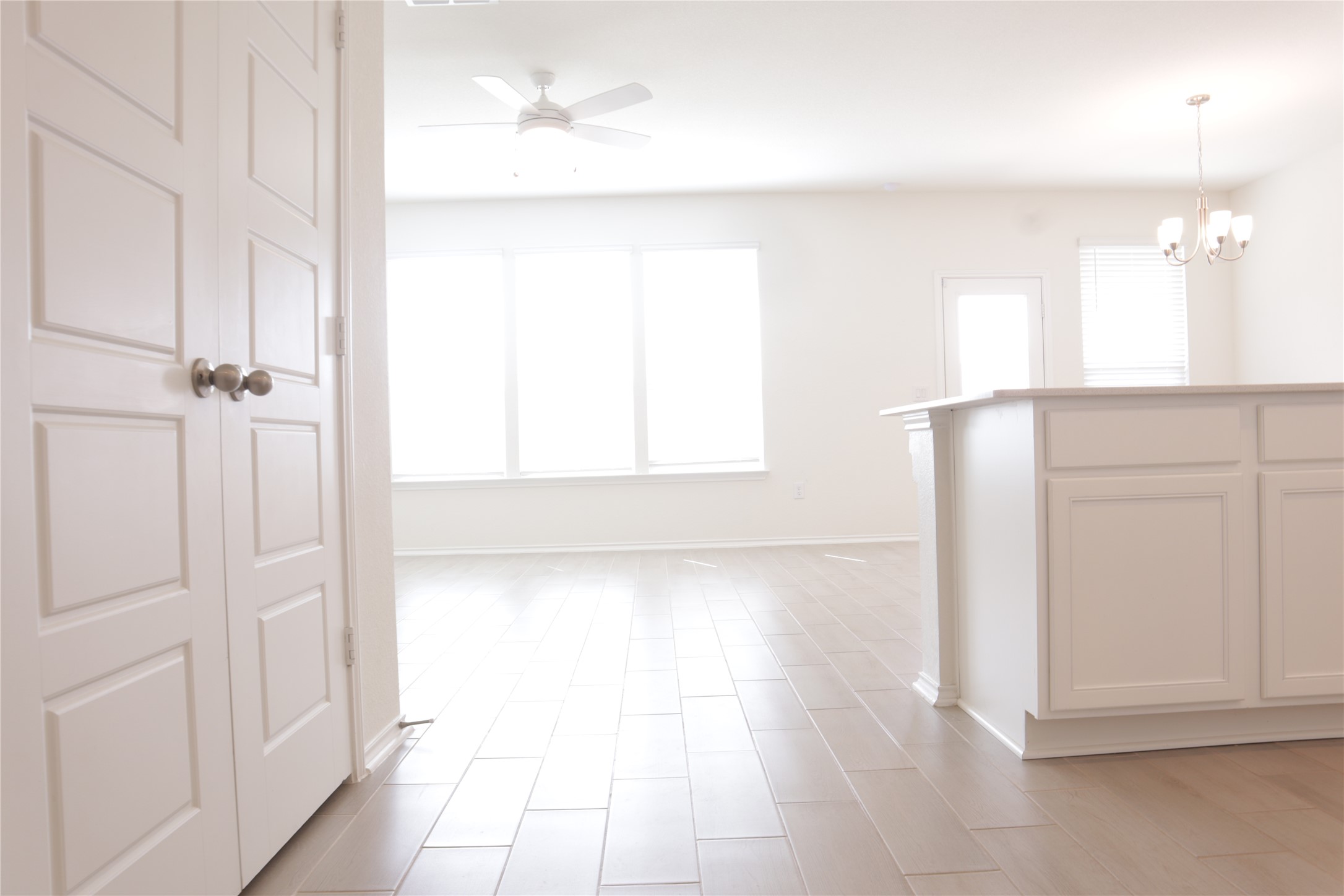 8111 Marigny Way Austin, TX 78744 - Photo 23 of 29 A luminous living space features broad windows and elegant tile flooring.