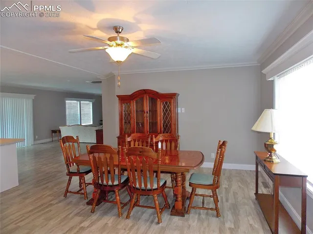 a view of a dining room with furniture window and wooden floor