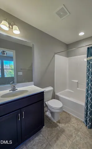 a bathroom with a toilet and a bathtub