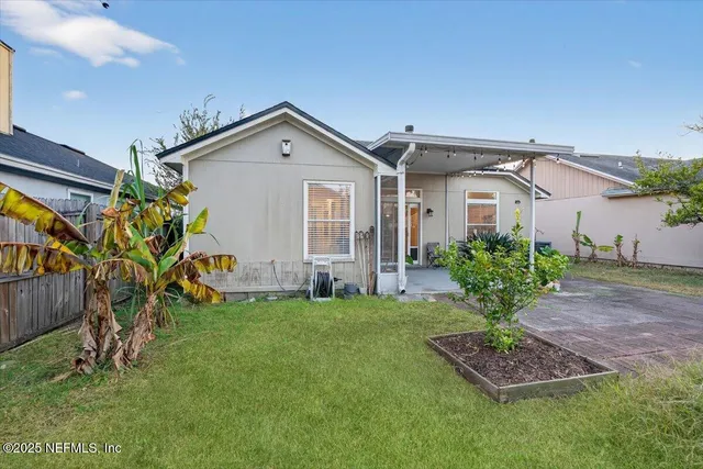 a view of a house with a yard and plants