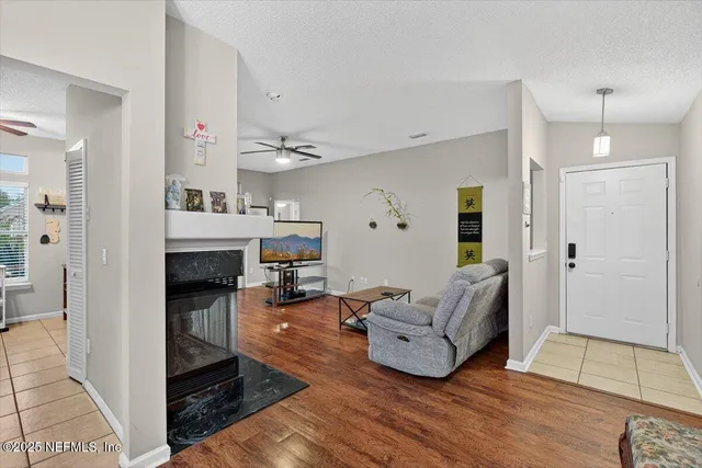 a living room with furniture and a fireplace