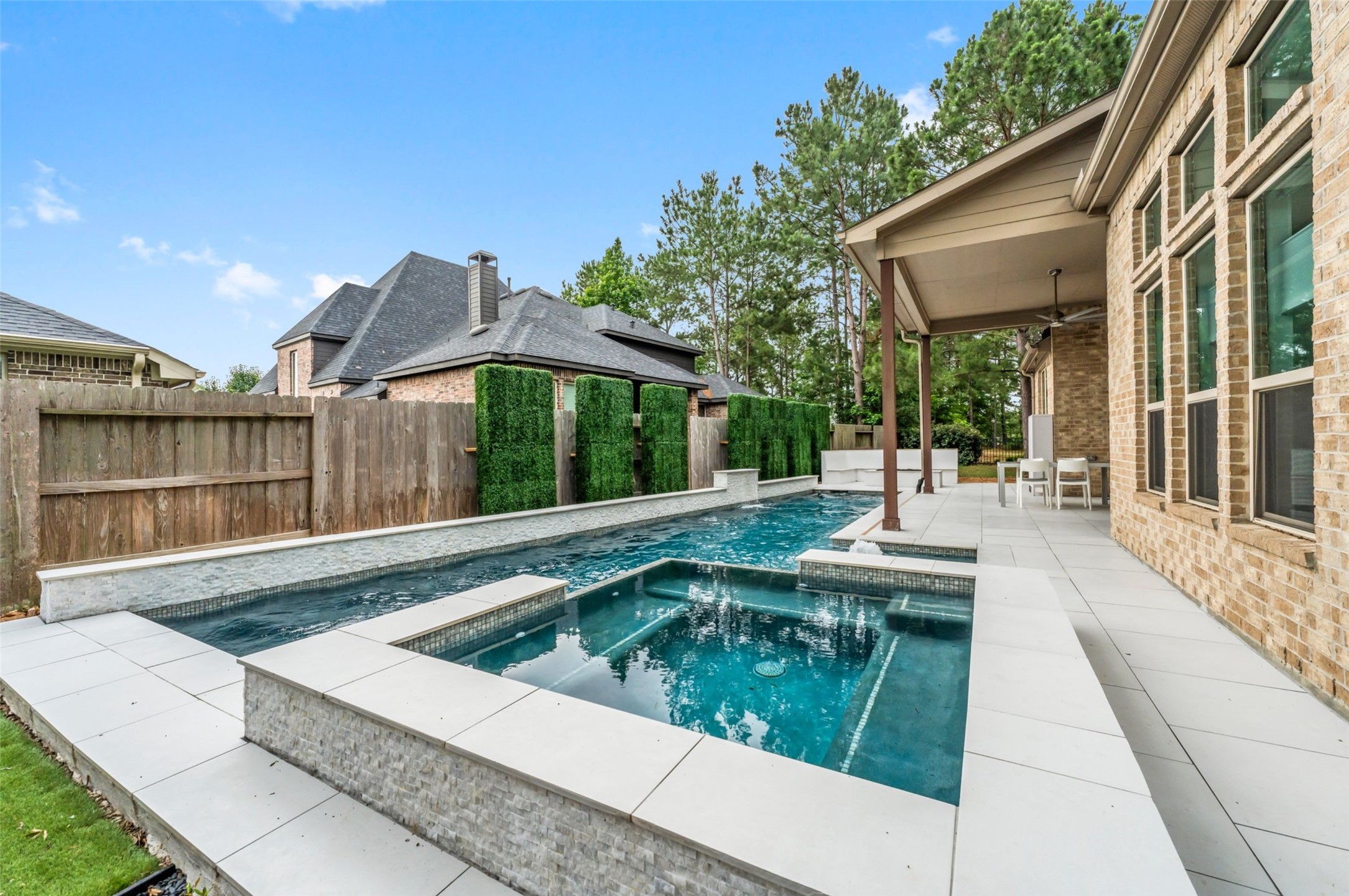 1053 Bat Hawk Court Conroe, TX 77385 - Photo 45 of 50 a view of a house with backyard and sitting area