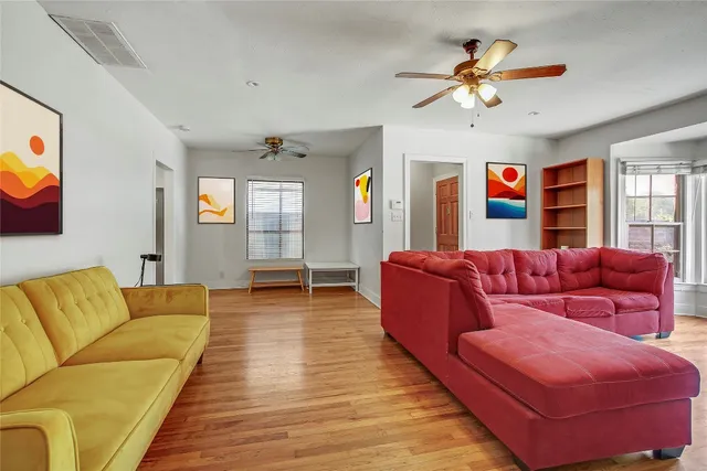 a view of room with wooden floor and ceiling fan