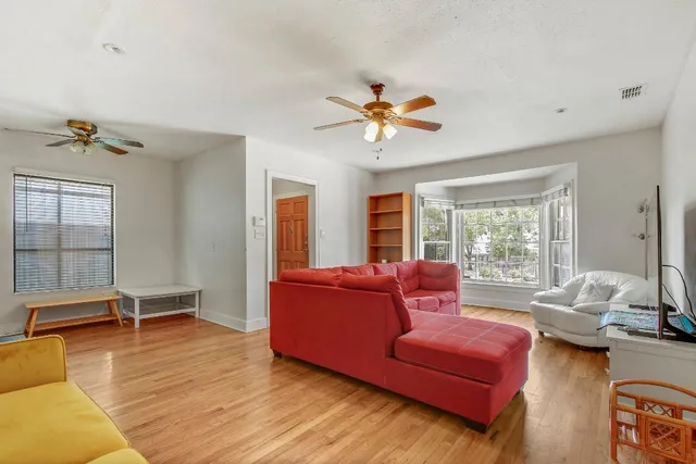 a kitchen with stainless steel appliances granite countertop a refrigerator a stove top oven a sink and dishwasher with wooden floor