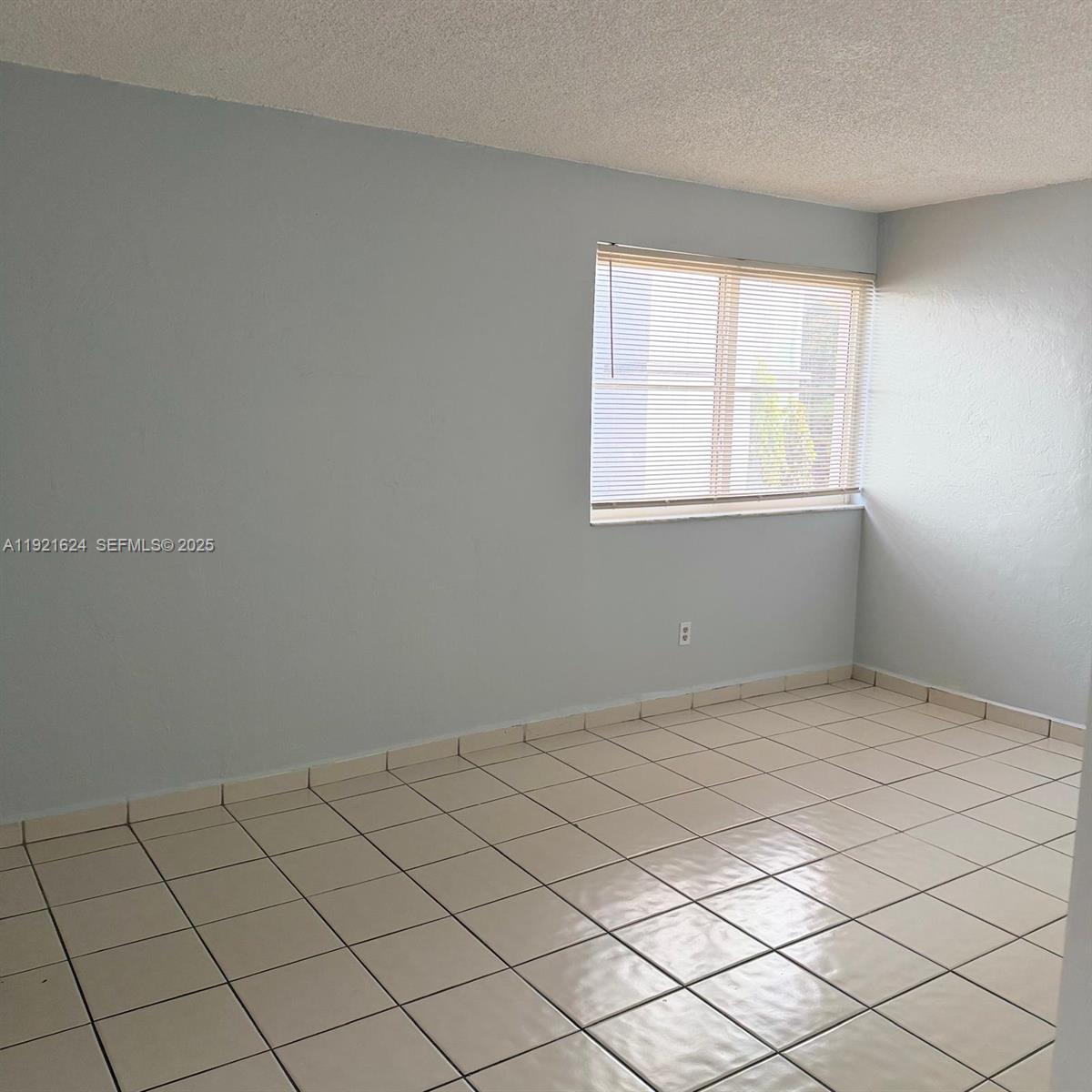 5501 Northwest 7th Street, Unit E301 Miami, FL 33126 - Photo 12 of 28 a view of room and window