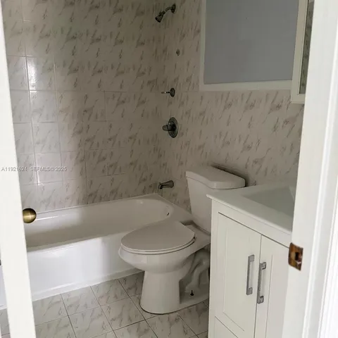 a bathroom with a shower and a toilet