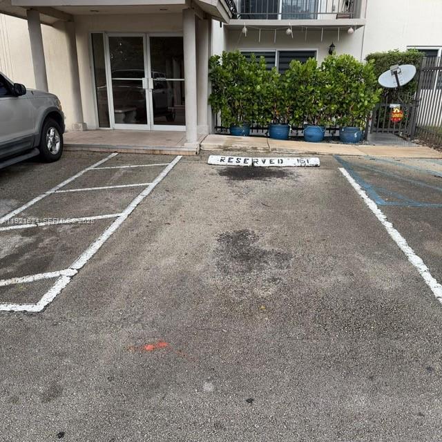 5501 Northwest 7th Street, Unit E301 Miami, FL 33126 - Photo 25 of 28 a view of a car parked front of a building