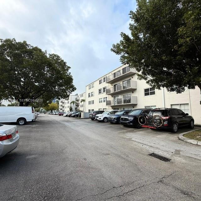 5501 Northwest 7th Street, Unit E301 Miami, FL 33126 - Photo 26 of 28 a view of a cars parked in front of a house
