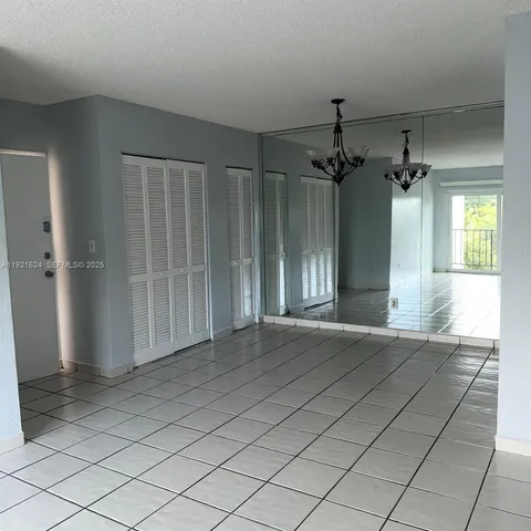 an empty room with entrance and windows