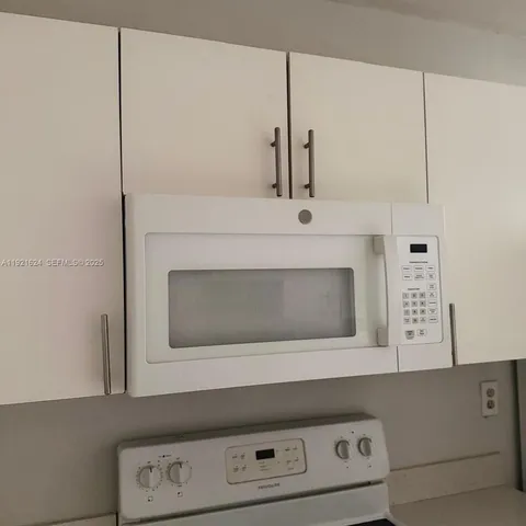 a stove top oven sitting inside of a kitchen
