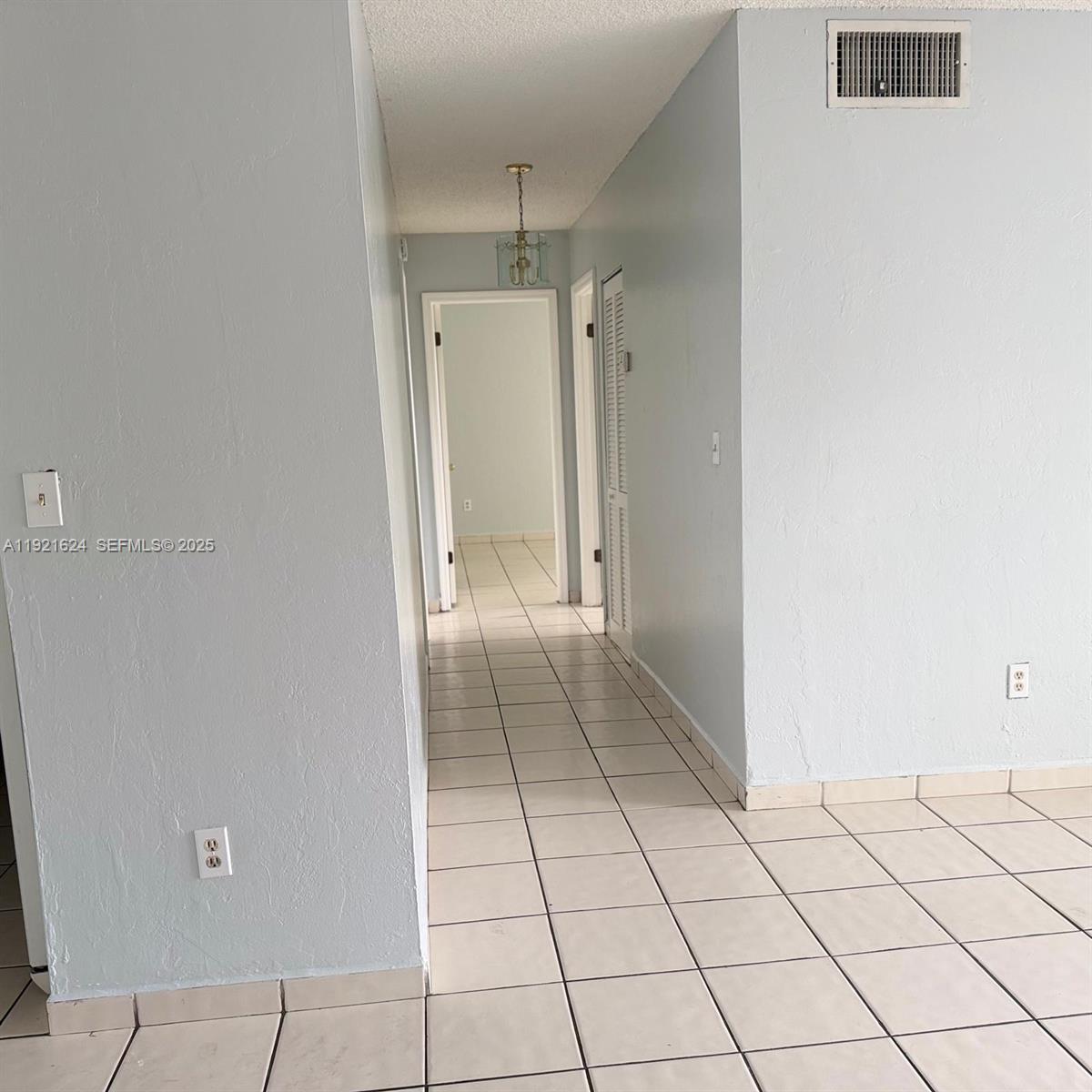 5501 Northwest 7th Street, Unit E301 Miami, FL 33126 - Photo 10 of 28 a view of an empty room and window