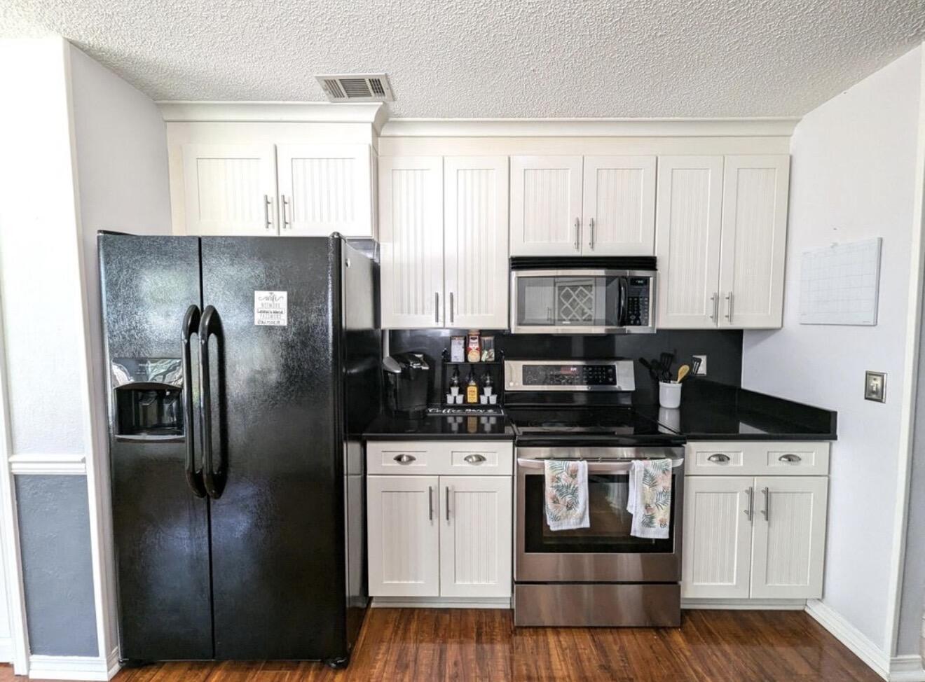 431 Sandy Ridge Circle Mary Esther, FL 32569 - Photo 13 of 16 a kitchen with stainless steel appliances kitchen island granite countertop a refrigerator stove and microwave
