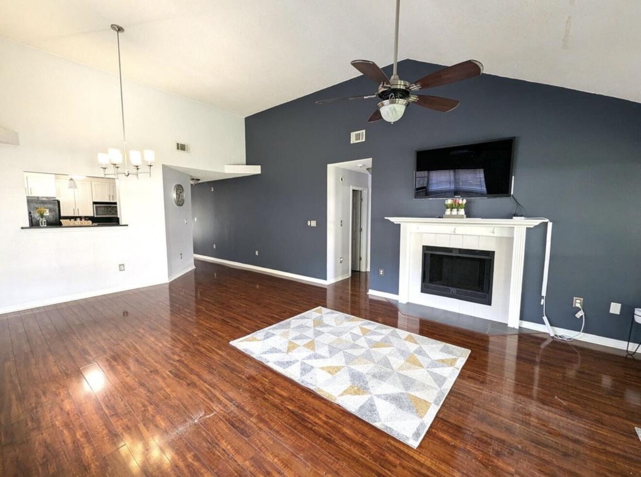 431 Sandy Ridge Circle Mary Esther, FL 32569 - Photo 4 of 16 a living room with stainless steel appliances furniture a fireplace and a flat screen tv