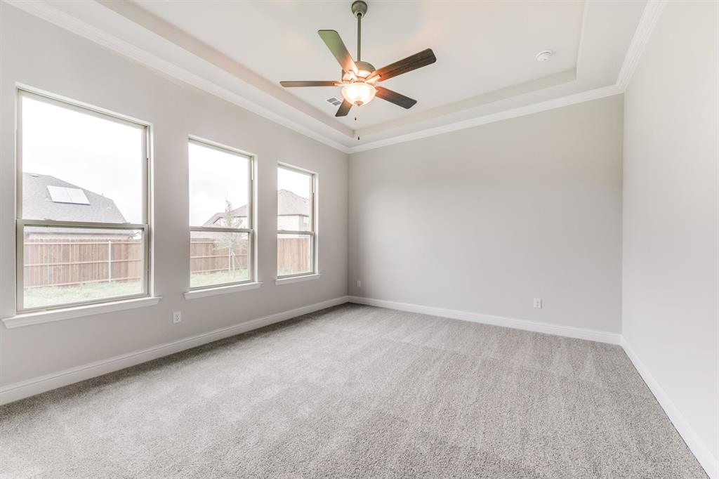 216 Lk Frst Trail Anna, TX 75409 - Photo 5 of 9 an empty room with window and a ceiling fan