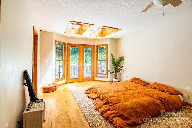 a bedroom with a bed and a large window