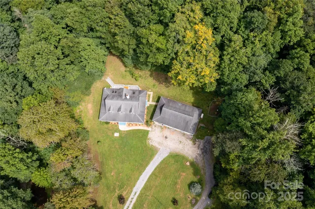 an aerial view of a house with a yard and garden