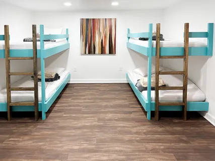 a hallway with stairs and a wooden floor