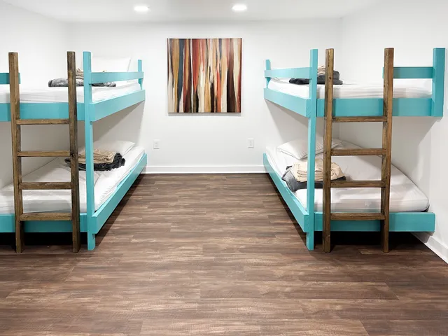 a hallway with stairs and a wooden floor