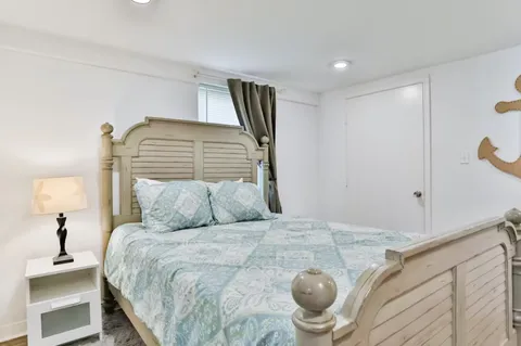 a bedroom with a large bed and a chandelier