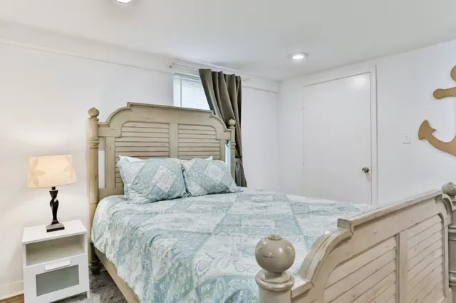 a bedroom with a large bed and a chandelier