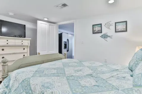 a bedroom with a flat screen tv and a bed