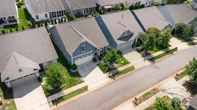 an aerial view of multiple houses with yard