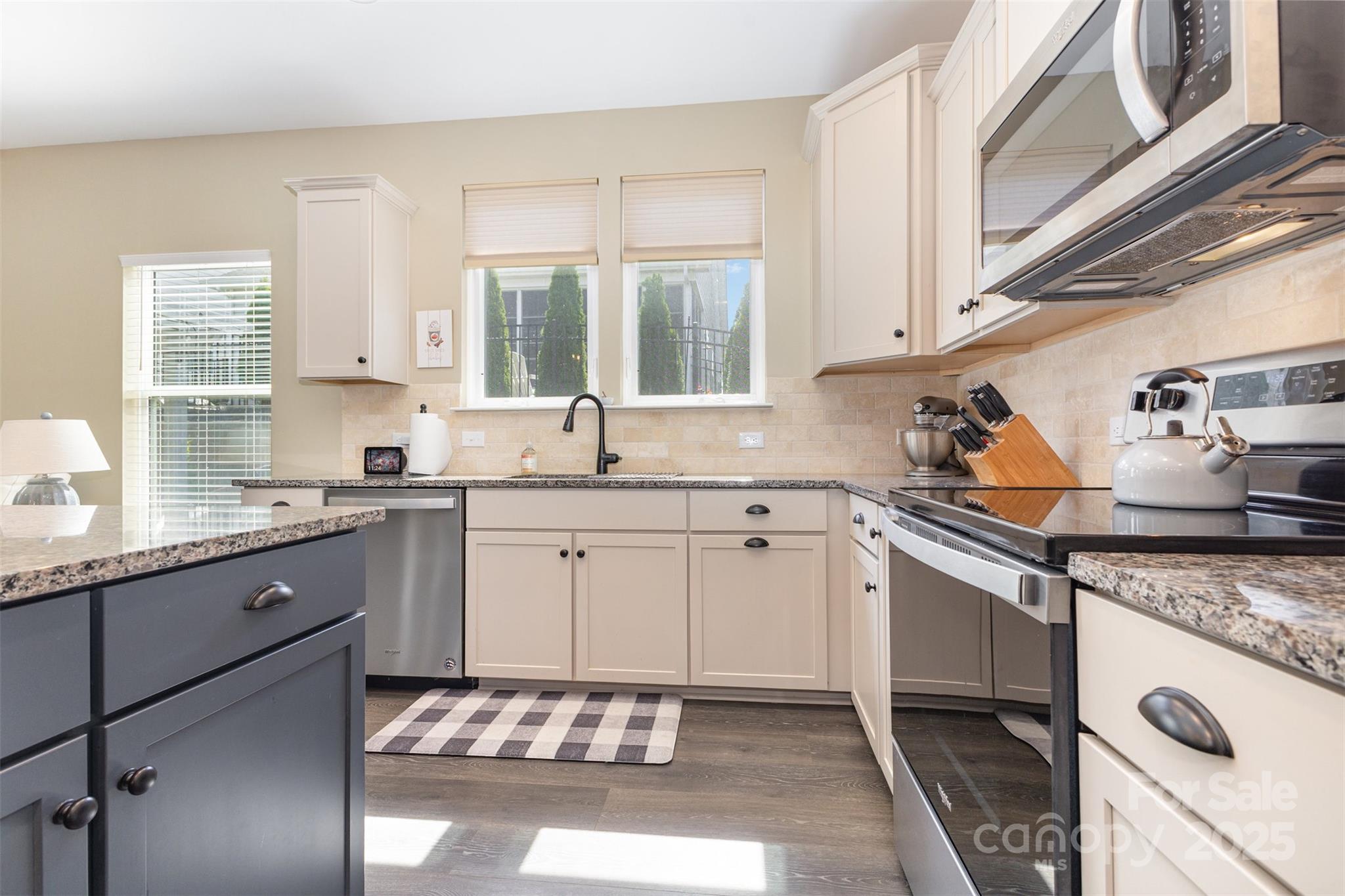 26043 Appleyard Court Lancaster, SC 29720 - Photo 5 of 23 a kitchen with granite countertop a sink stainless steel appliances white cabinets and a window