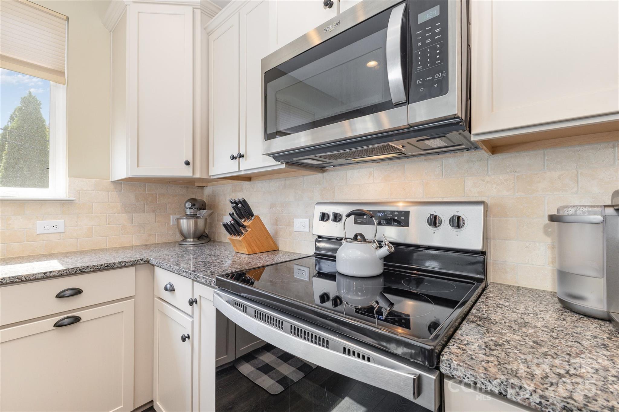 26043 Appleyard Court Lancaster, SC 29720 - Photo 6 of 23 a kitchen with a stove a microwave and cabinets