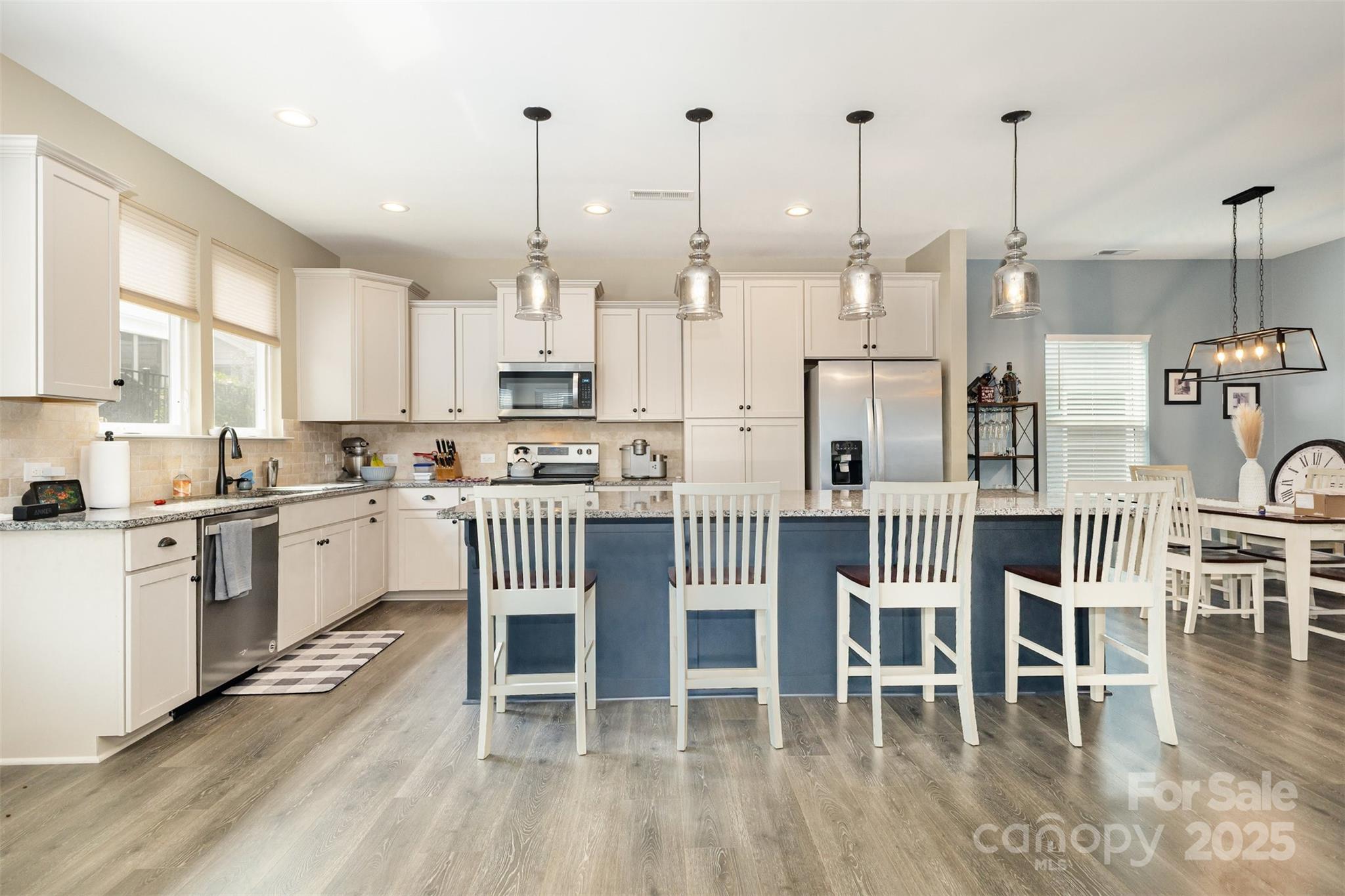 26043 Appleyard Court Lancaster, SC 29720 - Photo 7 of 23 a kitchen with a dining table chairs and white cabinets