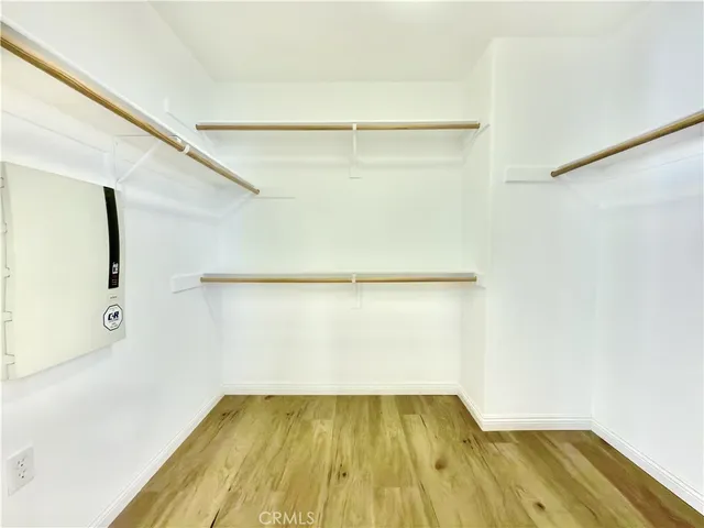 a view of a room with wooden floor and cabinet