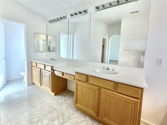 a bathroom with a granite countertop sink mirror and double