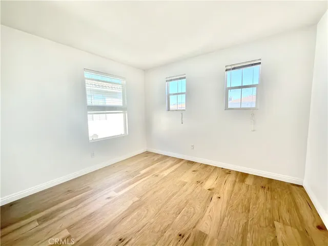 a view of an empty room with window and closet area