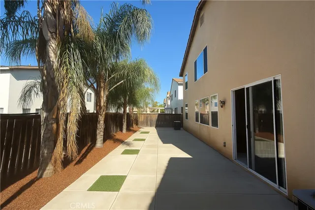 an aerial view of a house with a mountain