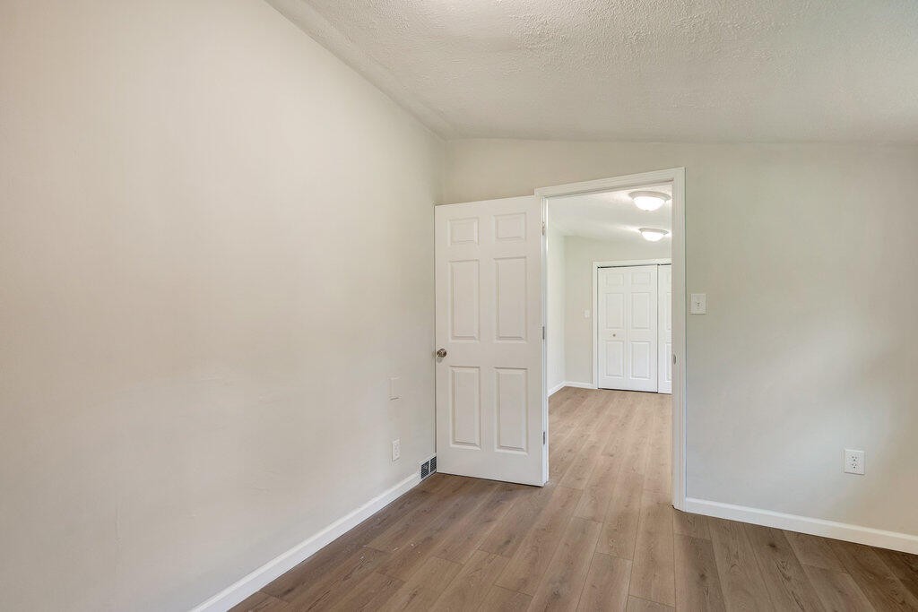 183 Earl Ezell Road Spring City, TN 37381 - Photo 14 of 30 a view of an empty room with wooden floor and closet