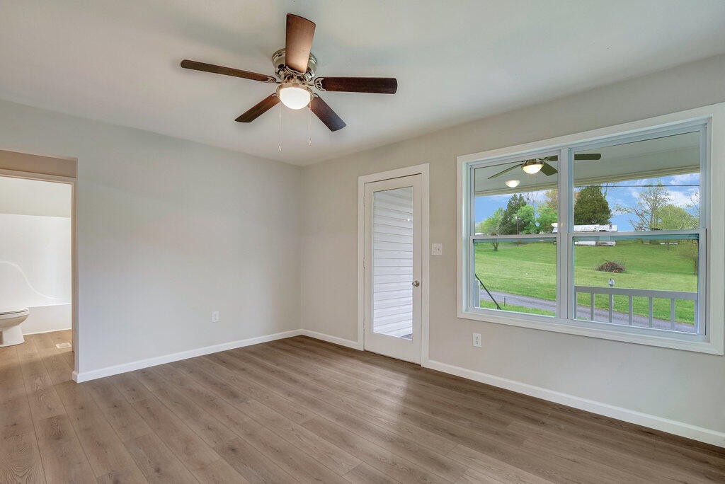 183 Earl Ezell Road Spring City, TN 37381 - Photo 16 of 30 a view of an empty room with a window and wooden floor