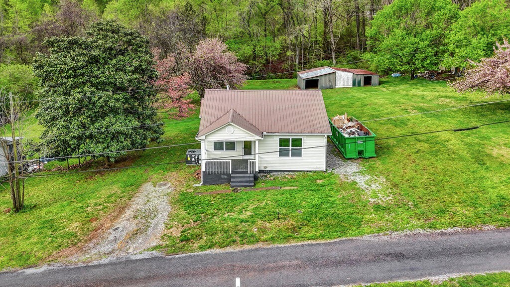 183 Earl Ezell Road Spring City, TN 37381 - Photo 19 of 30 a house with green field in front of it