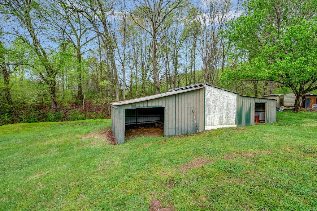 183 Earl Ezell Road Spring City, TN 37381 - Photo 26 of 30 a view of a backyard with large trees