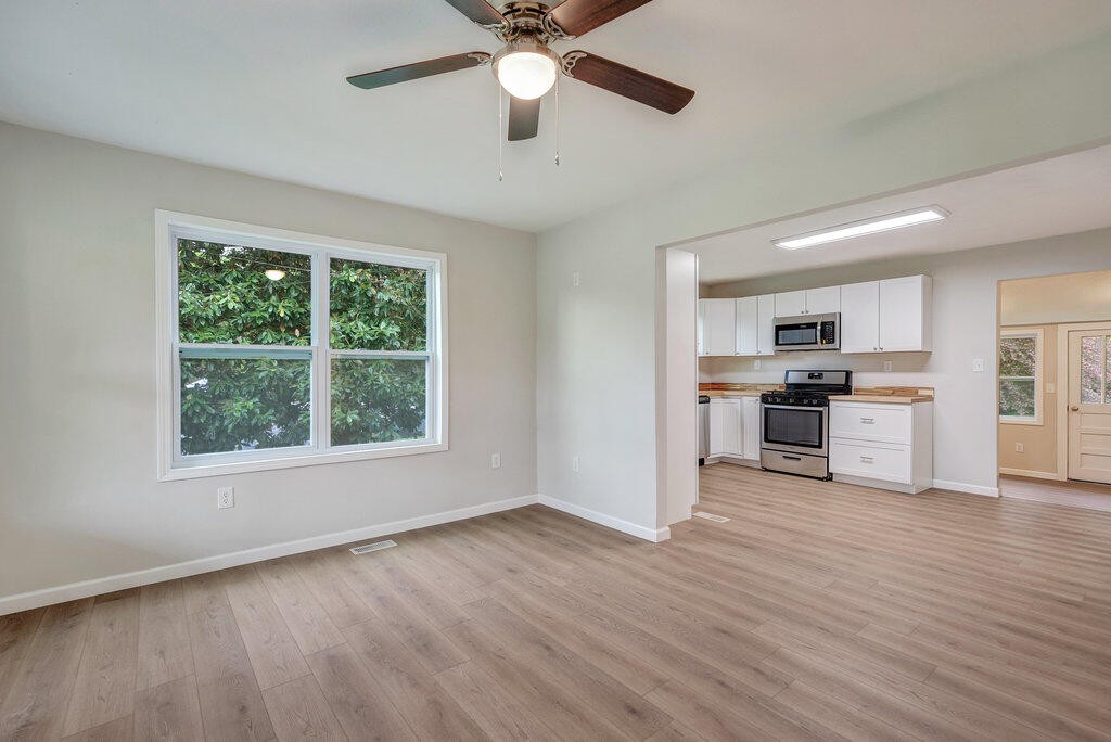 183 Earl Ezell Road Spring City, TN 37381 - Photo 6 of 30 a view of kitchen with granite countertop cabinets and wooden floor