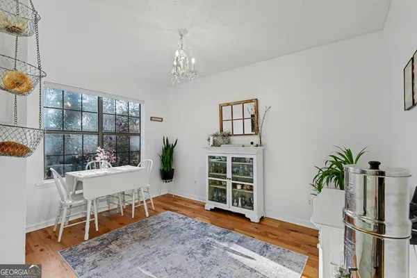 a kitchen with stainless steel appliances white cabinets a sink and a stove