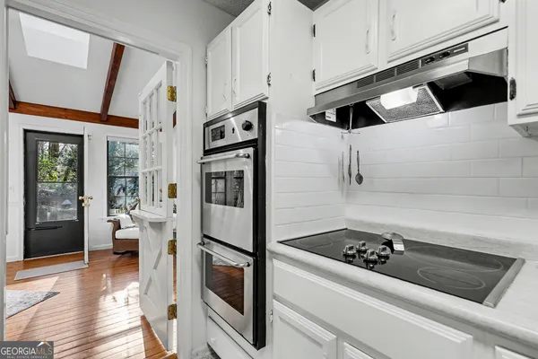 a spacious bedroom with a bed and a dresser