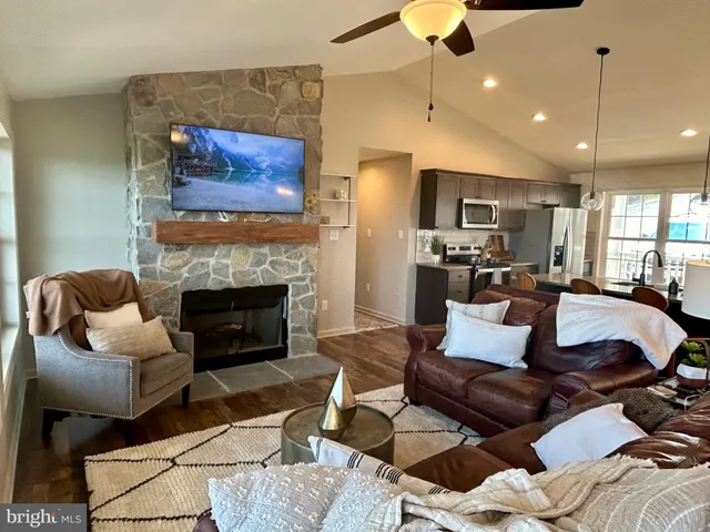 a living room with furniture and a fireplace