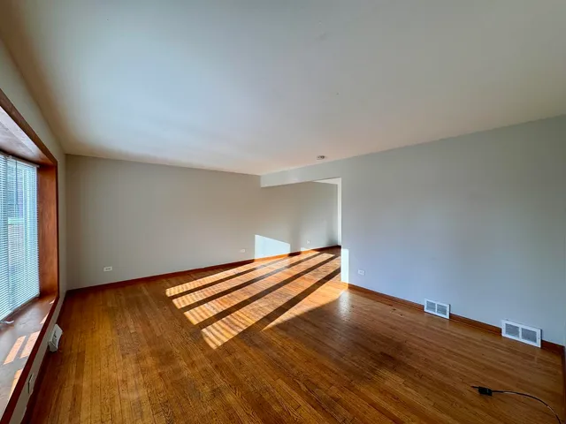 a view of room with wooden floor and window