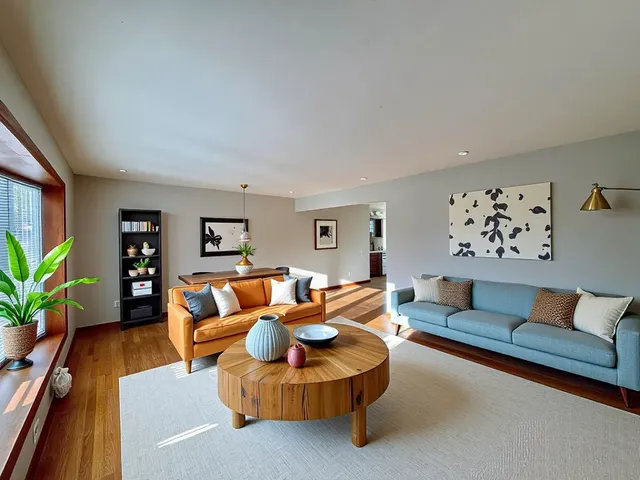 a living room with furniture and wooden floor